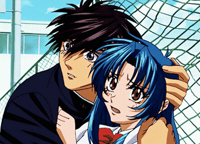 A Boy And A Girl Are Standing Next To Each Other In Front Of A Fence GIF