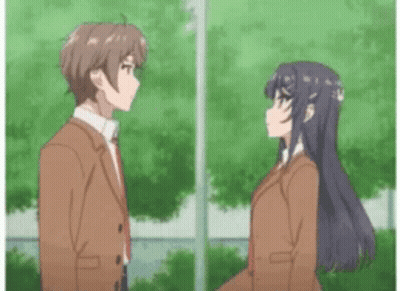 A Boy And A Girl Are Standing Next To Each Other In Front Of Trees . GIF