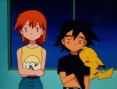 A Boy And A Girl Are Standing Next To Each Other With A Pikachu Between Them GIF