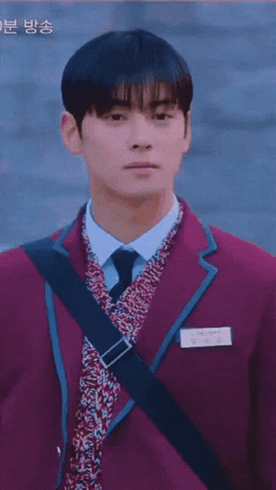 A Boy And A Girl Are Walking Down A Street . GIF