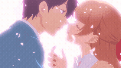 A Boy And A Girl Kissing With Petals Falling Around Them GIF