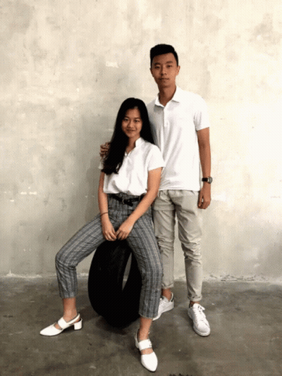 A Boy And A Girl Posing For A Picture With A Tire In The Background GIF