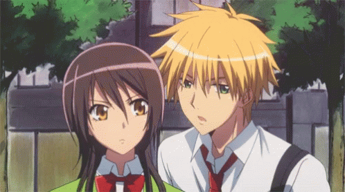 A Boy And A Girl Standing Next To Each Other GIF