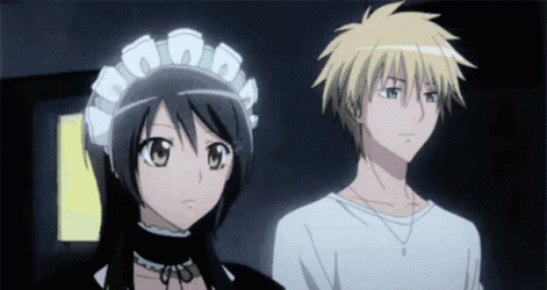 A Boy And A Girl Standing Next To Each Other GIF