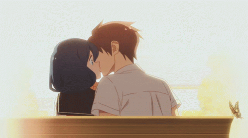 A Boy And Girl Are Kissing On A Bench GIF