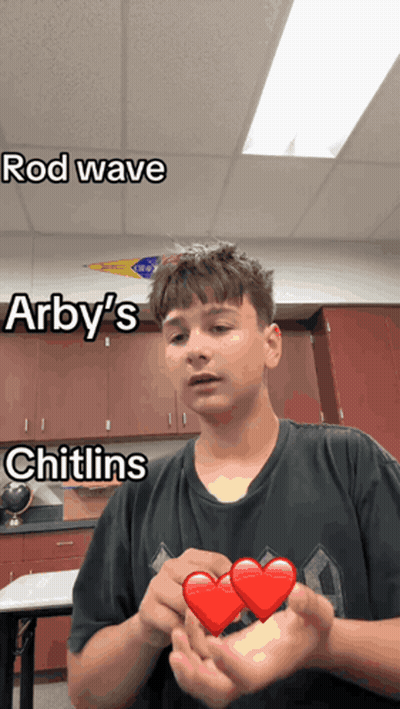 A Boy Holding A Heart With The Words Rod Wave Arby 'S And Chitlins Written On It GIF