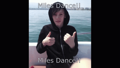 A Boy In A Black Hoodie Giving A Thumbs Up With The Words Miles Dance GIF