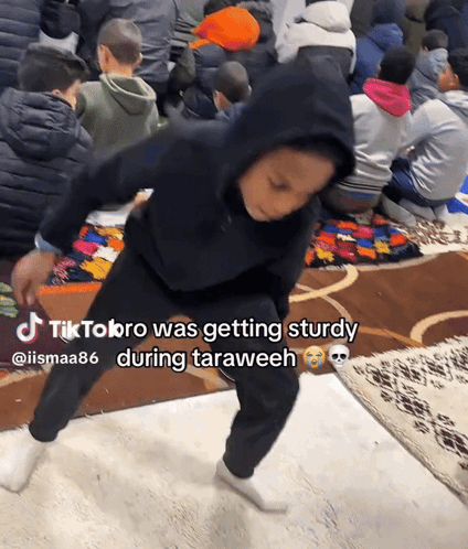 A Boy In A Black Hoodie Is Dancing In Front Of A Crowd Of People With Tiktok Bro Written In The Corner GIF