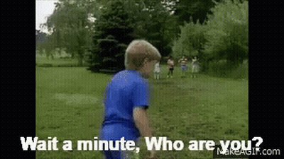 A Boy In A Blue Shirt Is Standing In A Grassy Field And Says Wait A Minute Who Are You GIF