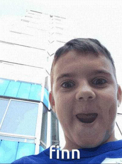 A Boy In A Blue Shirt With Finn Written On It GIF