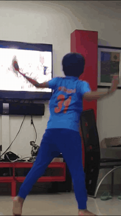 A Boy In A Blue Shirt With The Number 3 On The Back Is Playing A Video Game GIF