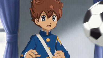 A Boy In A Blue Uniform Is Standing In Front Of A Window With A Soccer Ball In The Background GIF