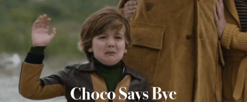 A Boy In A Brown Jacket Says Choco Says Bye In Front Of A Woman GIF