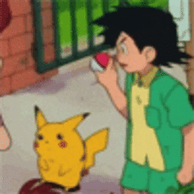 A Boy In A Green Shirt Is Standing Next To A Pikachu Holding A Pokemon Ball . GIF