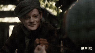 A Boy In A Hat Is Smiling In A Netflix Advertisement GIF