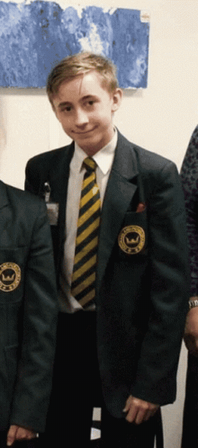 A Boy In A School Uniform Has A Patch On His Jacket That Says ' Williams ' On It GIF