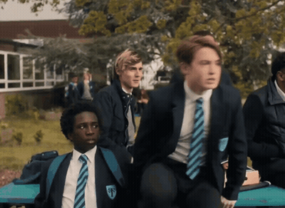 A Boy In A School Uniform Has The Letter T On His Collar GIF