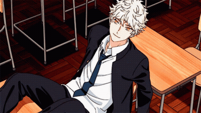 A Boy In A Suit And Tie Is Laying On A Desk GIF