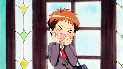 A Boy In A Suit And Tie Is Making A Funny Face With His Eyes Closed GIF