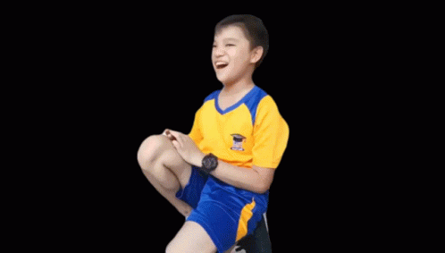 A Boy In A Yellow Shirt And Blue Shorts Is Clapping GIF