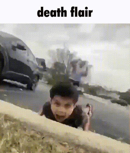 A Boy Is Crawling On The Side Of The Road With The Words Death Flair Above Him GIF