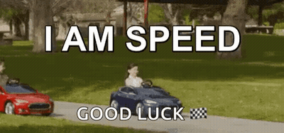 A Boy Is Driving A Toy Car Down A Road . GIF
