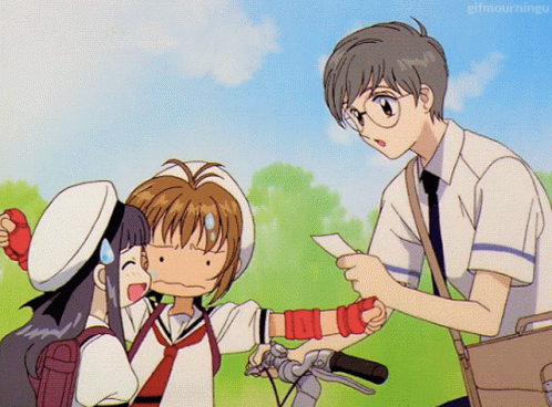 A Boy Is Giving A Piece Of Paper To A Girl Who Is Holding A Bicycle GIF