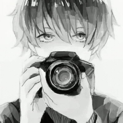 A Boy Is Holding A Camera In Front Of His Face . GIF