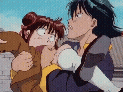 A Boy Is Holding A Girl In His Arms And The Girl Is Making A Funny Face GIF