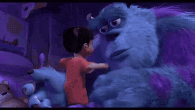 A Boy Is Hugging A Purple Monster From The Movie Monsters Inc . GIF