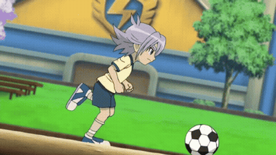 A Boy Is Kicking A Soccer Ball On A Field GIF