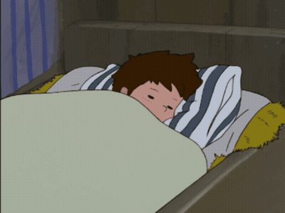 A Boy Is Laying In Bed With A Striped Pillow GIF