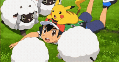 A Boy Is Laying On The Grass With A Pikachu On His Head GIF