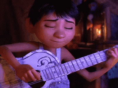 A Boy Is Playing A Guitar With His Eyes Closed GIF