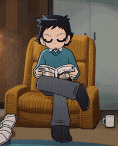A Boy Is Sitting In A Chair Reading A Magazine GIF
