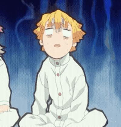 A Boy Is Sitting On The Floor With His Eyes Closed . GIF