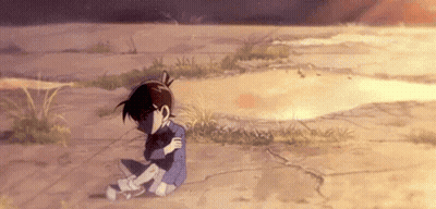 A Boy Is Sitting On The Ground With His Arms Around His Neck . GIF