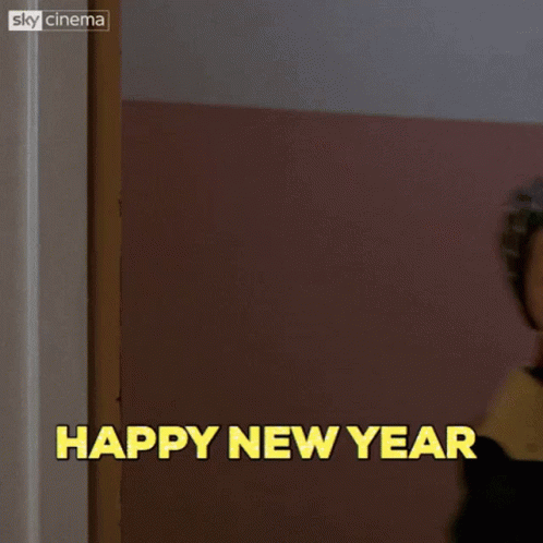A Boy Is Standing In Front Of A Door With The Words Happy New Year Above Him GIF