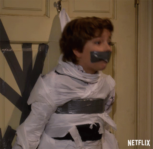A Boy Is Taped To A Door With Duct Tape And A Netflix Logo Behind Him GIF