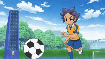 A Boy Kicks A Soccer Ball In Front Of A Bs Japan Tower GIF