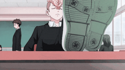A Boy Sitting At A Desk With His Eyes Closed And A Shoe On His Head GIF