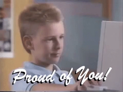 A Boy Sitting In Front Of A Computer With The Words " Proud Of You " Written On The Bottom GIF