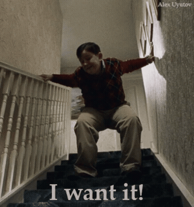 A Boy Sitting On A Set Of Stairs With The Words " I Want It " Written On The Bottom GIF