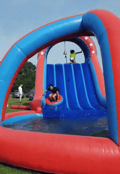 A Boy Slides Down A Red And Blue Water Slide GIF