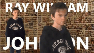 A Boy Wearing A Black Abercrombie Sweatshirt Stands In Front Of A Wall GIF
