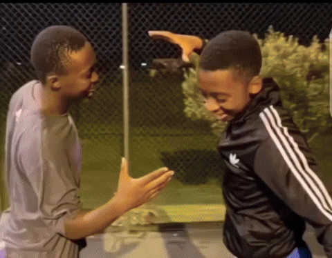 A Boy Wearing A Black Adidas Jacket Is Standing Next To Another Boy GIF