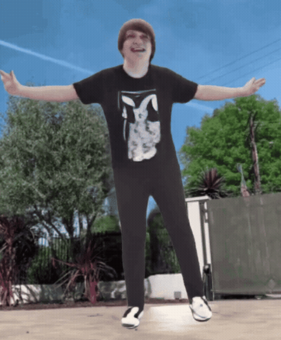 A Boy Wearing A Black Shirt With A Bunny On It GIF