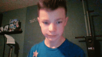 A Boy Wearing A Blue Shirt With A White Star On It GIF