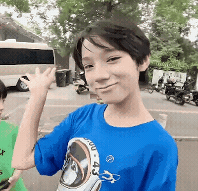 A Boy Wearing A Blue Shirt With The Number 4 On The Front GIF