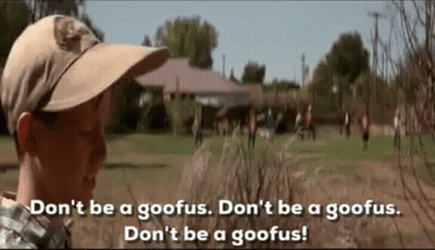 A Boy Wearing A Hat Is Standing In A Field With A Group Of People . GIF